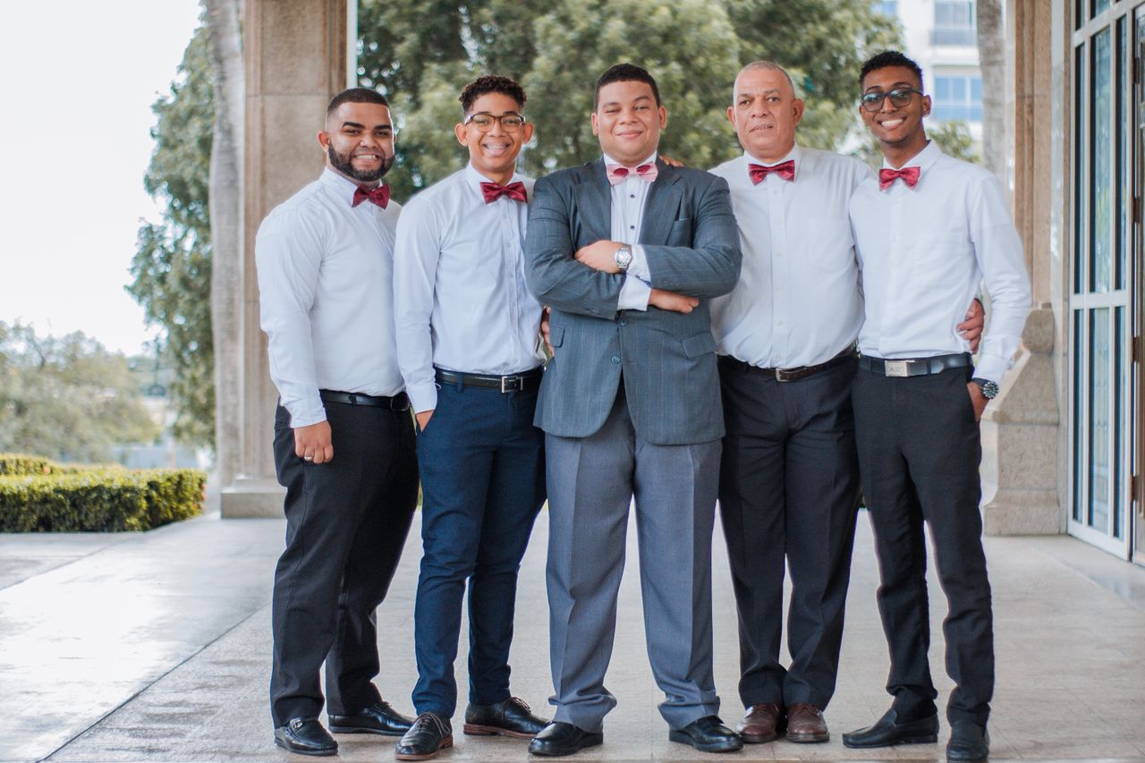 A group of men in formal attire posing together, showcasing togetherness and celebration.
