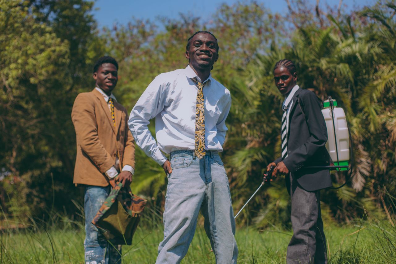 gallery-04 Three young men in business attire posing confidently outdoors in Accra, Ghana.